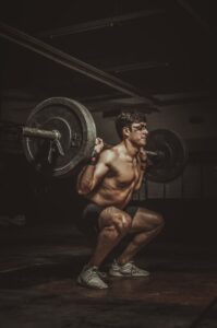 Lifter performing a barbell squat in the gym
